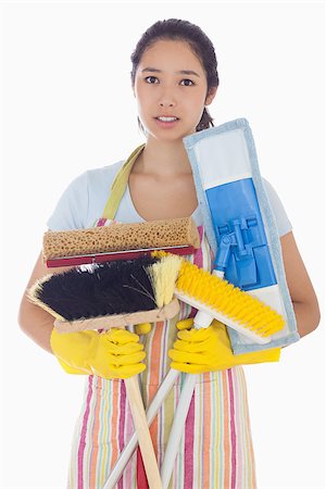 simsearch:400-06863660,k - Frowning woman in apron and rubber gloves holding brushes and mops Stock Photo - Budget Royalty-Free & Subscription, Code: 400-06863565