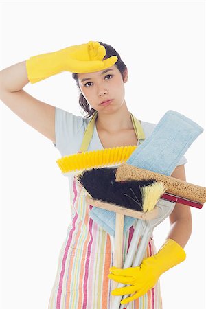 simsearch:400-06863660,k - Tired woman in apron and rubber gloves holding cleaning tools Stock Photo - Budget Royalty-Free & Subscription, Code: 400-06863586
