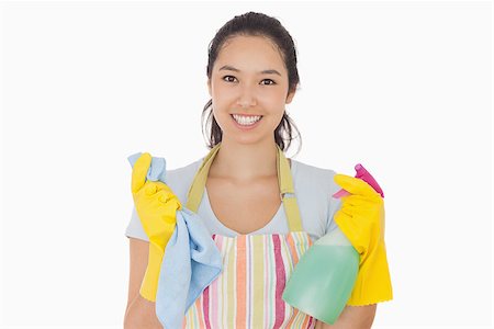 simsearch:400-06863660,k - Smiling woman holding cloth and spray bottle in apron and rubber gloves Stock Photo - Budget Royalty-Free & Subscription, Code: 400-06863589