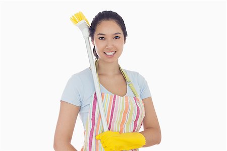 simsearch:400-06863660,k - Happy woman in gloves with broom on her shoulder Stock Photo - Budget Royalty-Free & Subscription, Code: 400-06863580