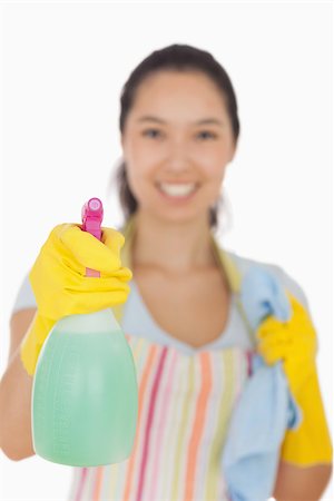 simsearch:400-06863660,k - Smiling woman in apron and gloves holding spray bottle and cloth Stock Photo - Budget Royalty-Free & Subscription, Code: 400-06863598