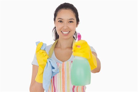 simsearch:400-06863660,k - Cheerful woman holding up spray bottle in rubber gloves and apron Stock Photo - Budget Royalty-Free & Subscription, Code: 400-06863591