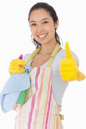 simsearch:400-06863660,k - Smiling woman in apron holding cleaning products giving thumbs up Stock Photo - Budget Royalty-Free & Subscription, Code: 400-06863633