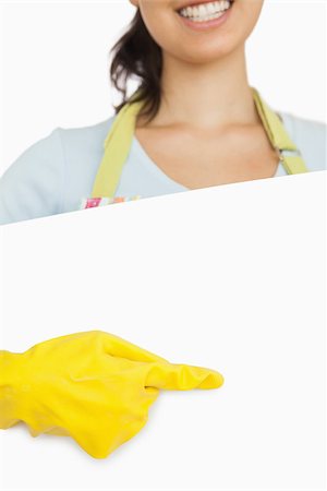 simsearch:400-06863660,k - Smiling woman in rubber gloves and apron standing behind board and pointing Stock Photo - Budget Royalty-Free & Subscription, Code: 400-06863679