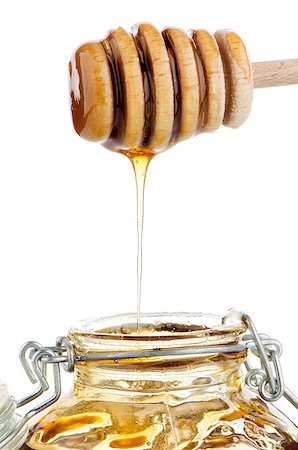simsearch:400-05135233,k - Jar of honey with wooden drizzler isolated on white background Foto de stock - Super Valor sin royalties y Suscripción, Código: 400-06875037