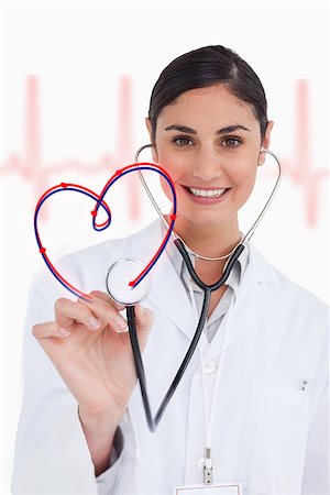 Happy doctor holding up stethoscope to heart design on ECG background Stock Photo - Budget Royalty-Free & Subscription, Code: 400-06875743