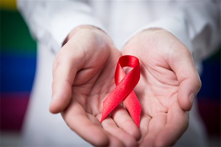 equality background hands - Man in shirt holding red aids ribbon on rainbow background Stock Photo - Budget Royalty-Free & Subscription, Code: 400-06876231