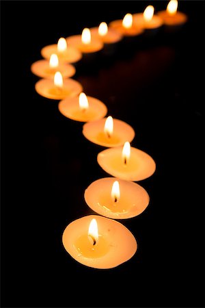 Tealight candles lighting in a curved line in the dark Stock Photo - Budget Royalty-Free & Subscription, Code: 400-06877258