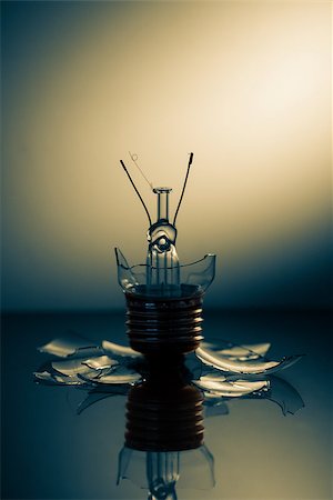 Clear light bulb broken on a reflective surface Stock Photo - Budget Royalty-Free & Subscription, Code: 400-06878156
