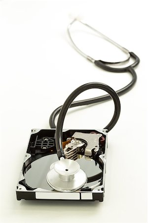 disk drive - Disk drive with stethoscope resting on it on white background Stock Photo - Budget Royalty-Free & Subscription, Code: 400-06878351