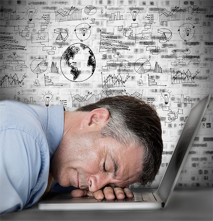 Businessman sleeping on his laptop with drawings and charts on the wall Stock Photo - Budget Royalty-Free & Subscription, Code: 400-06878915