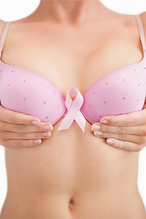 simsearch:400-07835111,k - Closeup of woman with breast cancer awareness ribbon attached to bra over white background Stock Photo - Budget Royalty-Free & Subscription, Code: 400-06870717