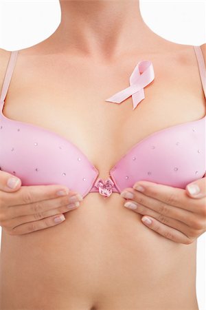 simsearch:400-07835111,k - Closeup of woman in bra with breast cancer awareness ribbon over white background Stock Photo - Budget Royalty-Free & Subscription, Code: 400-06870719