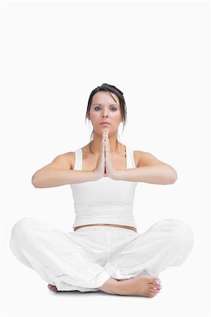simsearch:400-06872329,k - Portrait of young woman with crossed legs in praying position over white background Stock Photo - Budget Royalty-Free & Subscription, Code: 400-06871996
