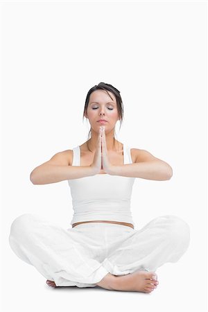 simsearch:400-06872329,k - Young woman with crossed legs in praying position over white background Stock Photo - Budget Royalty-Free & Subscription, Code: 400-06871997