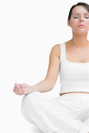 simsearch:400-06872329,k - Young woman sitting in lotus position over white background Stock Photo - Budget Royalty-Free & Subscription, Code: 400-06872000