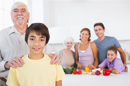 Grandfather and grandson standing beside the kitchen counter with family behind them Stock Photo - Budget Royalty-Free & Subscription, Code: 400-06872823