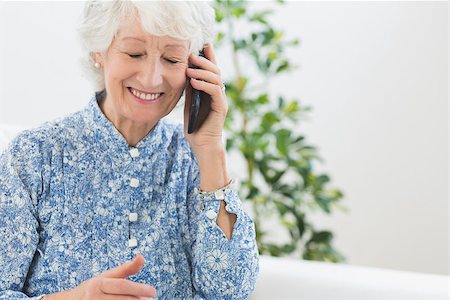 phone one person adult smile elderly - Elderly happy woman calling someone in the living room Stock Photo - Budget Royalty-Free & Subscription, Code: 400-06873122