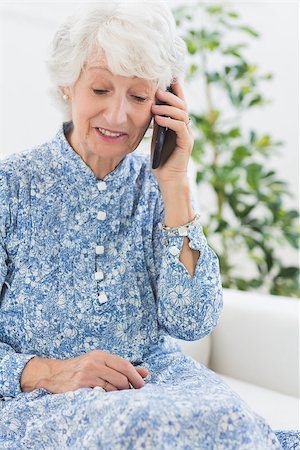 phone one person adult smile elderly - Elderly cheerful woman on a mobile phone on a sofa Stock Photo - Budget Royalty-Free & Subscription, Code: 400-06873123