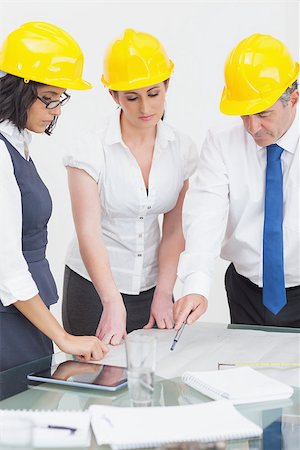 Architects looking at plan in office Stock Photo - Budget Royalty-Free & Subscription, Code: 400-06873839