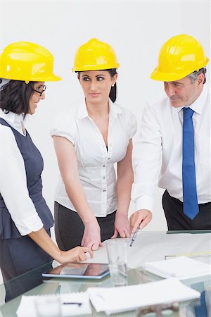 Architects looking at construction plan in office Stock Photo - Budget Royalty-Free & Subscription, Code: 400-06873840