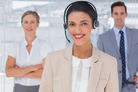 Attractive woman with headset standing in front of business team Stock Photo - Budget Royalty-Free & Subscription, Code: 400-06884657