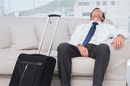 Businessman napping on couch in bright office Stock Photo - Budget Royalty-Free & Subscription, Code: 400-06884763