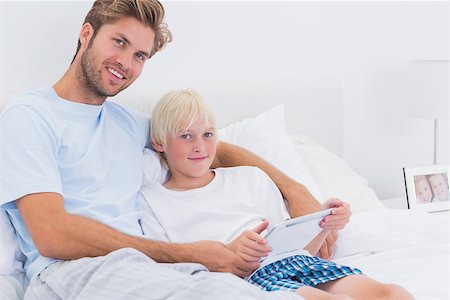 simsearch:400-06872329,k - Father and his son using a tablet in bed Stock Photo - Budget Royalty-Free & Subscription, Code: 400-06886539