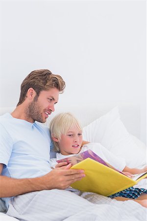simsearch:400-06872329,k - Father reading a story to his cute son in bed Stock Photo - Budget Royalty-Free & Subscription, Code: 400-06886556