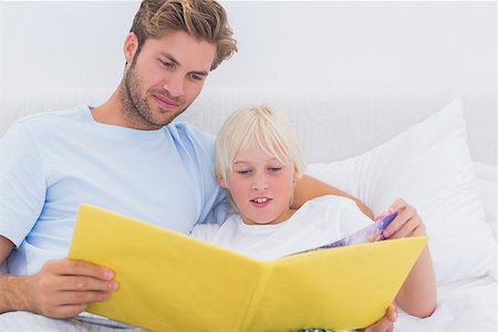 simsearch:400-06872329,k - Father reading a story to his son in bed Stock Photo - Budget Royalty-Free & Subscription, Code: 400-06886551