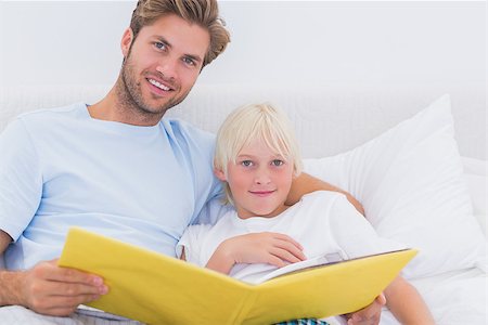 simsearch:400-06872329,k - Handsome father reading a story to his son in bed Stock Photo - Budget Royalty-Free & Subscription, Code: 400-06886552