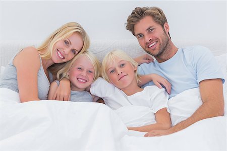 simsearch:400-06872329,k - Portrait of a family sitting in bed Stock Photo - Budget Royalty-Free & Subscription, Code: 400-06886579