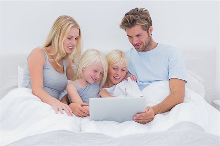 simsearch:400-06872329,k - Beautiful family using a laptop lying in bed Stock Photo - Budget Royalty-Free & Subscription, Code: 400-06886584