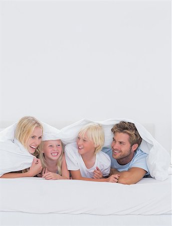 simsearch:400-06872329,k - Cheerful family under the duvet at home in bed Stock Photo - Budget Royalty-Free & Subscription, Code: 400-06886594