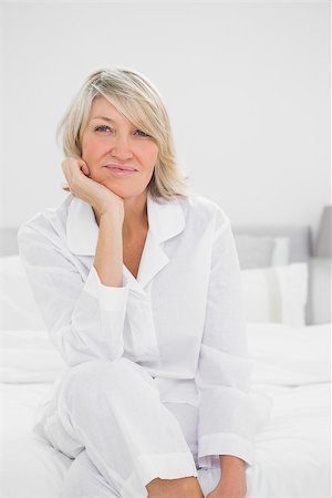 simsearch:400-06872329,k - Cheerful  woman sitting in her bedroom looking at camera Stock Photo - Budget Royalty-Free & Subscription, Code: 400-06891057