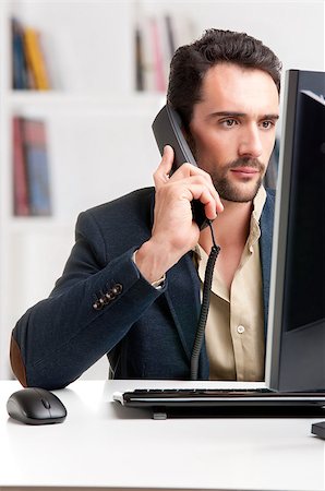 ruigsantos (artist) - Man looking at a computer screen, on the phone, thinking about the job at hand Stock Photo - Budget Royalty-Free & Subscription, Code: 400-06914144