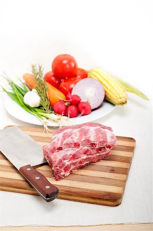 chopping fresh pork ribs with vegetables and herbs ready to cook Stock Photo - Budget Royalty-Free & Subscription, Code: 400-06916543