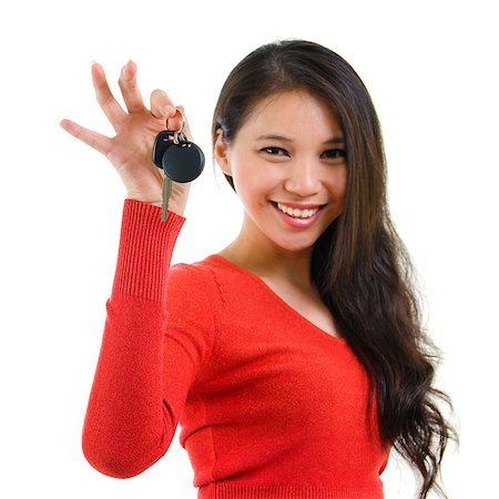 Young woman holding her first own car key isolated on white background. Beautiful mixed race Caucasian Southeast Asian woman model. Foto de stock - Super Valor sin royalties y Suscripción, Código: 400-06918402