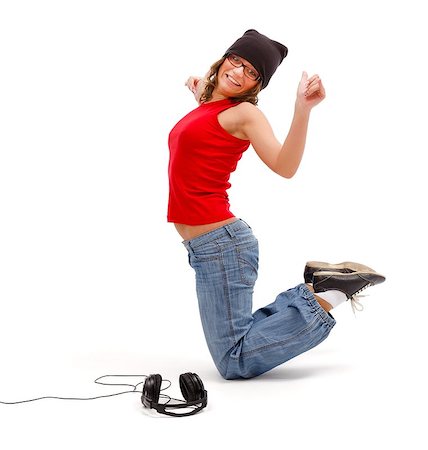 Happy young girl standing on knees while dancing and listening to music Stock Photo - Budget Royalty-Free & Subscription, Code: 400-06912583