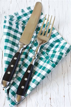 Rustic cutlery with green provence napkin on an old wooden table. Stock Photo - Budget Royalty-Free & Subscription, Code: 400-06913269