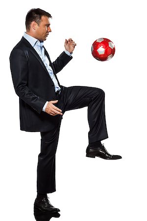 one caucasian business man playing juggling soccer ball in studio isolated on white background Stock Photo - Budget Royalty-Free & Subscription, Code: 400-06913698