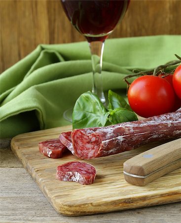simsearch:400-06207145,k - Still life of delicacy salami, tomatoes and basil -  rustic style Stock Photo - Budget Royalty-Free & Subscription, Code: 400-06924372