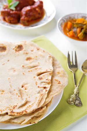 simsearch:400-07418409,k - Chapatti roti or Flat bread, curry chicken and dhal. Indian food on dining table. Stock Photo - Budget Royalty-Free & Subscription, Code: 400-06924794