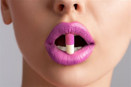 sensual female mouth in close-up portrait with coloured pill between lips Stock Photo - Budget Royalty-Free & Subscription, Code: 400-06926523