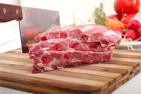 chopping fresh pork ribs with vegetables and herbs ready to cook Stock Photo - Budget Royalty-Free & Subscription, Code: 400-06927769