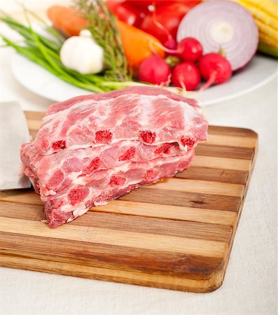 chopping fresh pork ribs with vegetables and herbs ready to cook Stock Photo - Budget Royalty-Free & Subscription, Code: 400-06921945