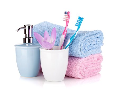 Toothbrush, soap, two towels and flower. Isolated on white background Photographie de stock - Aubaine LD & Abonnement, Code: 400-06922388