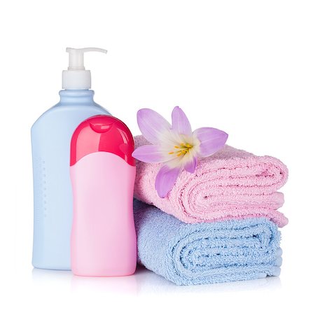 Shampoo and gel bottles with towels and flower. Isolated on white background Photographie de stock - Aubaine LD & Abonnement, Code: 400-06922392
