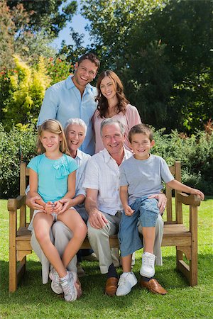 family and park and camera - Smiling multi generation family sitting on a bench in park looking at camera Stock Photo - Budget Royalty-Free & Subscription, Code: 400-06934103