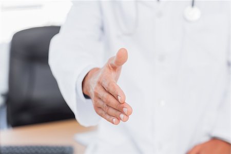 simsearch:694-03331631,k - Doctor presenting his hand for a handshake in medical office Stock Photo - Budget Royalty-Free & Subscription, Code: 400-06930465